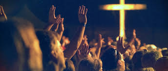 people-worshipping-with-cross-in-background